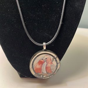 N76. Ceramic pendant necklace on black cord.